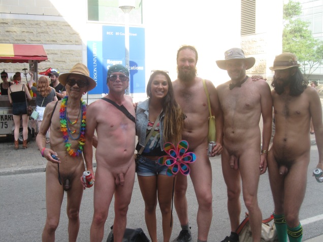 Five naked men at the Toronto Pride Parade, including Jade Sambrook, pose with a woman who requested a photo